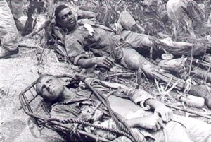 Two wounded Marines from "I" company 7th Marines await evacuation by Helicopter. The Marines engaged the NVA South of the Demilitarized Zone.